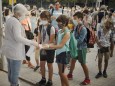 Students wearing face masks to prevent the spread of coronavirus disinfect their hands before entering their school in Barcelona, Spain, Monday, Sept. 14, 2020.