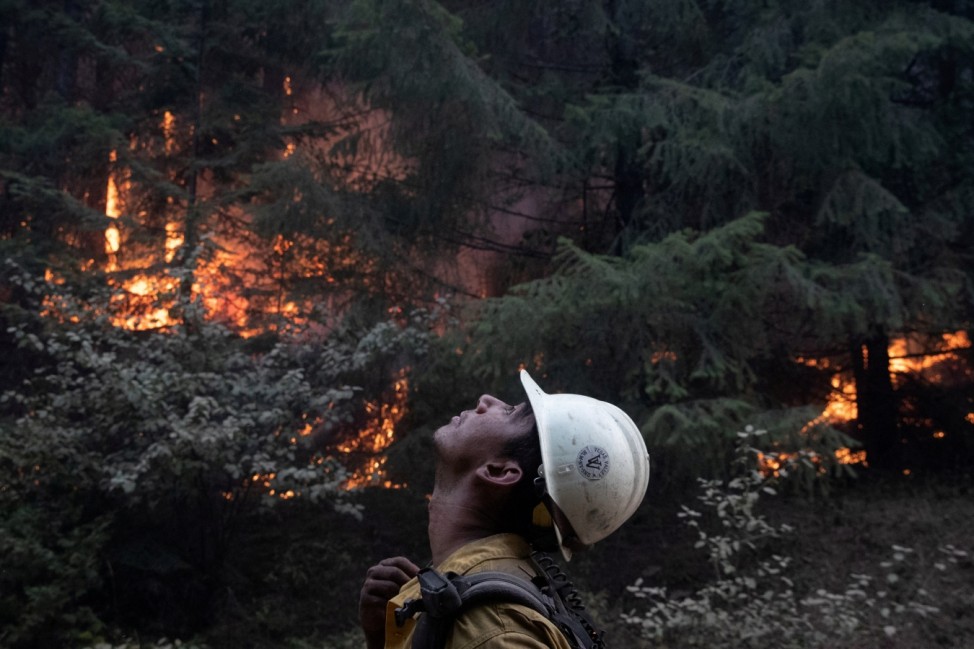 Firefighter monitors ambers from a firing operation near the Obenchain Fire in Butte Falls, Oregon