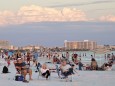 Visitors enjoy Siesta Key Beach as the sun sets over the Gulf of Mexico,