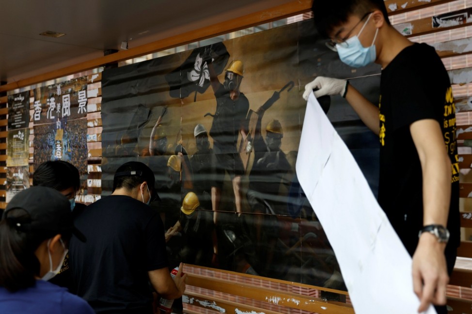 University of Hong Kong's students put up posters on Lennon Walls in campus to promote the upcoming pro-democracy protest and demand the release of 12 Hong Kong activists detained in the Chinese mainland after attempting to flee to Taiwan, in Hong Kong