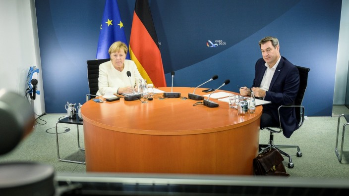 German Chancellor Angela Merkel and Bavarian federal Prime Minister Markus Soeder are seen in a video conferencing room in Berlin