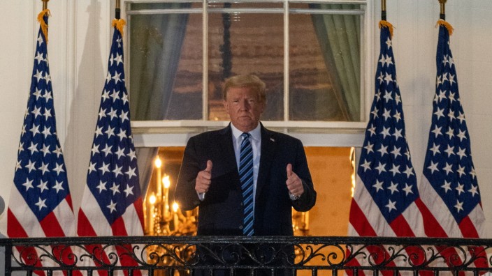 President Donald J. Trump gives the thumbs up from the Truman Balcony at the White House following several days at Walt