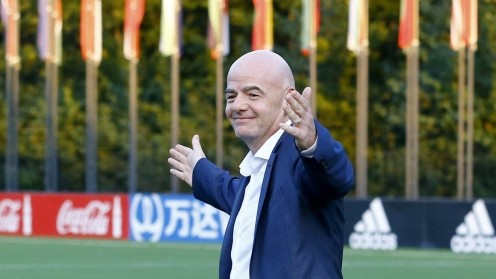 FIFA's President Infantino walks over a pitch in Zurich