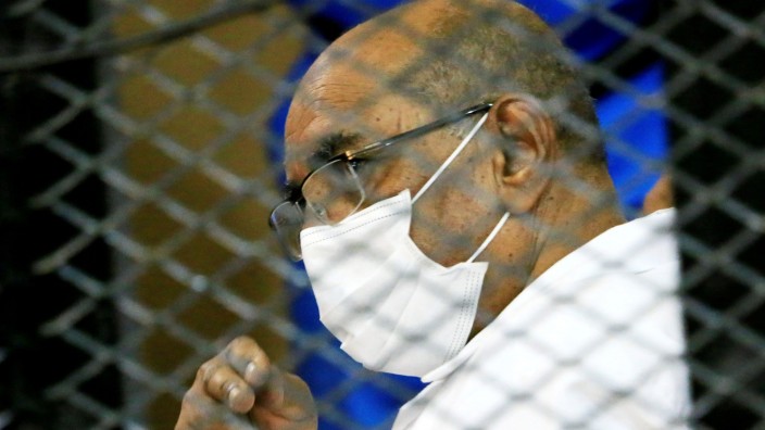 FILE PHOTO: Sudan's ousted President Omar al-Bashir is seen inside the defendant's cage during his and some of his former allies trial over the 1989 military coup that brought the autocrat to power in 1989, at a courthouse in Khartoum