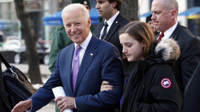 U.S. Vice President Biden leaves accompanied by his granddaughter Finnegan after the 51st Munich Security Conference in Munich