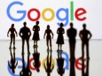 FILE PHOTO: FILE PHOTO: Small toy figures are seen in front of Google logo in this illustration picture