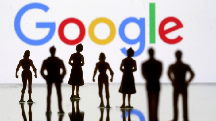 FILE PHOTO: FILE PHOTO: Small toy figures are seen in front of Google logo in this illustration picture