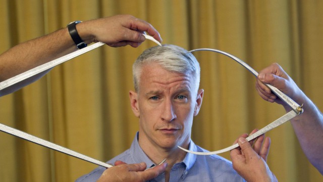 Television journalist Anderson Cooper poses for a portrait while being measured for a wax figure by Madame Tussauds in New York