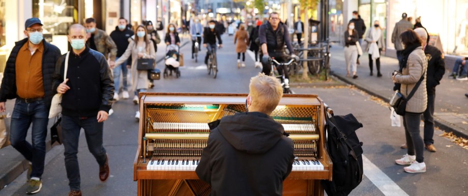 Ein Mann spielt während der Corona-Pandemie Klavier in der Kölner Innenstadt