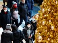 People wear protective face masks as they walk beside Christmas decoration amid the coronavirus disease (COVID-19) outbreak in Berlin