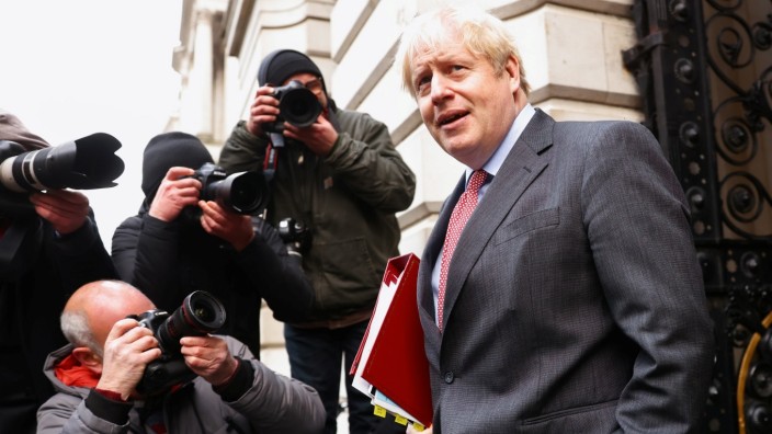 Britain's Prime Minister Boris Johnson walks near Downing Street, in London