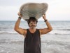 Portrait of mature man carrying surfboard at the sea model released Symbolfoto PUBLICATIONxINxGERxSUIxAUTxHUNxONLY DLTSF