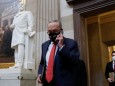 Senate Minority Leader Schumer speaks on a cell phone before attending a meeting on Capitol Hill in Washington