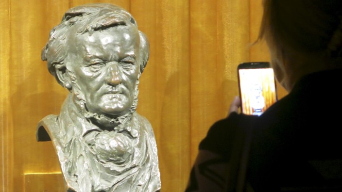 A visitor takes a picture of a bust of German composer Richard Wagner at the Richard Wagner Museum in Bayreuth