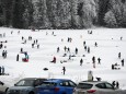 People ice-skate and play hockey on the frozen lake Spitzingsee, near the resort town of Schliersee