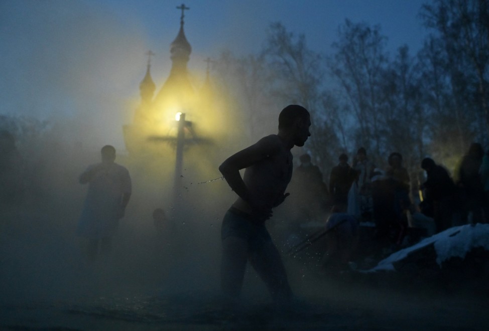 People take a dip during celebrations of the Orthodox Christian feast of Epiphany in Omsk Region