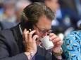 Andreas SCHEUER (Bundesverkehrsminister), telefoniert mit Smartphone und trinkt aus einer Tasse, Einzelbild,angeschnitte
