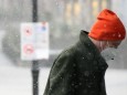 Winter wetter mit Schnee , a men with Safety mask FFP2 is seen under the snow during the Hard Lockdown of the Covid 19
