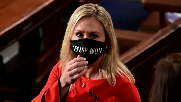 FILE PHOTO: U.S. Rep. Marjorie Taylor Greene (R-GA) wears a 'Trump Won' face mask as she arrives to take her oath of office as a member of the 117th Congress in Washington