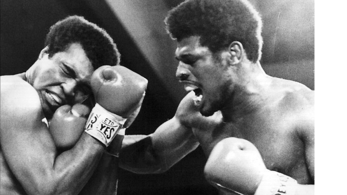 LAS VEGAS ---- HEAVYWEIGHT CHAMPION MUHAMMAD ALI (LEFT) GRIMACES AS CHALLENGER LEON SPINKS GETS IN A STINGING RIGHT CRO