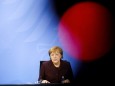 German Chancellor Angela Merkel briefs the media during a news conference in Berlin
