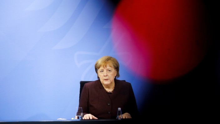 German Chancellor Angela Merkel briefs the media during a news conference in Berlin