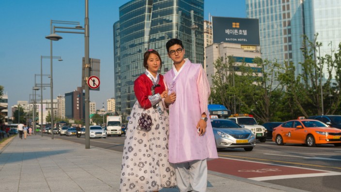 SOUTH KOREA - COUPLE IN TRADITIONAL KOREAN CLOTHING IN THE STREET - SEOUL Couple in traditional korean clothing in the s
