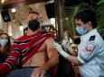 A man receives a vaccination against the coronavirus disease (COVID-19) as part of a Tel Aviv municipality initiative offering a free drink at a bar to residents getting the shot, in Tel Aviv