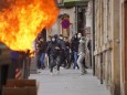 A container burns during riots at a demonstration against the imprisonment of Pablo Hasel on the sixth day of protests,