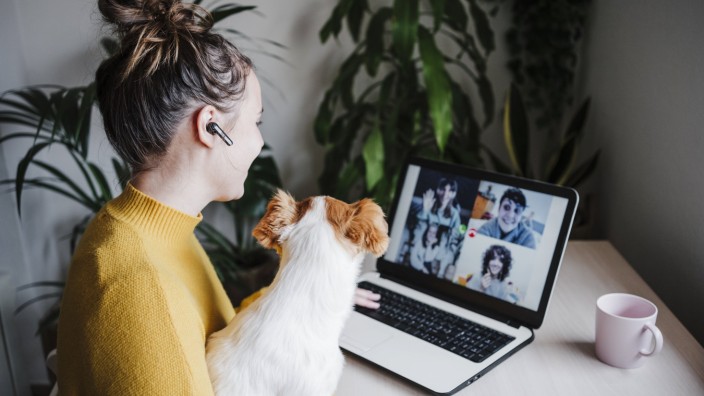 Woman talking with friends on video conference over digital tablet while sitting with pet at home model released Symbolf