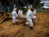 Workers bury a covid-19 victim at the Nossa Senhora Aparecida Cemetery, in Manaus, Amazonas, Brazil, 01 March 2021 (iss