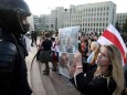 FILE PHOTO: Women take part in a rally against police brutality following protests to reject the presidential election results in Minsk