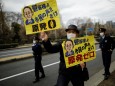 An anti-nuclear protester raises a placard during a rally in front of the parliament building in Tokyo