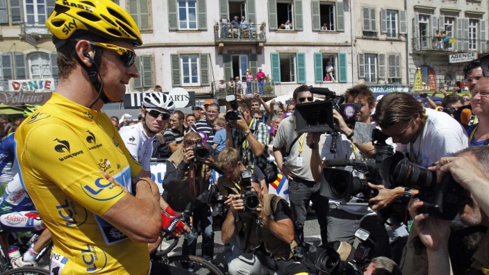 Sky Procycling rider and leader's yellow jersey Wiggins of Britain is surrounded by the media as he awaits the start of the tenth stage of the 99th Tour de France cycling race between Macon and Bellegarde-sur-Valserine