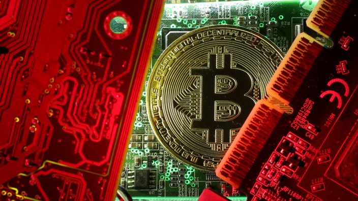 FILE PHOTO: Copy of bitcoin standing on PC motherboard is seen in this illustration picture
