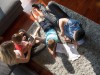 Happy Young Family Playing Together at home on the floor using a tablet and a children’s drawing set top view,mode