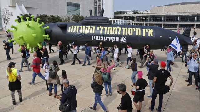 Israel: Israelis carry inflatable balloons depicting a black submarine as they protest against Benjamin Netanyahu.