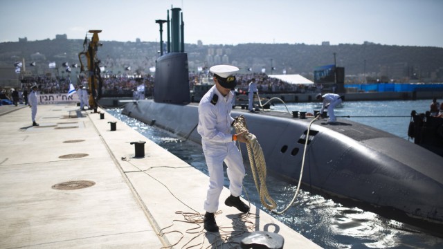 140923 HAIFA Sept 23 2014 An Israeli naval officer holds the mooring rope of an INS Tanin