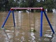 NSW WET WEATHER, A semi-submerged child'!s playground on the banks of the flooded Nepean River at Trench Reserve at Penri