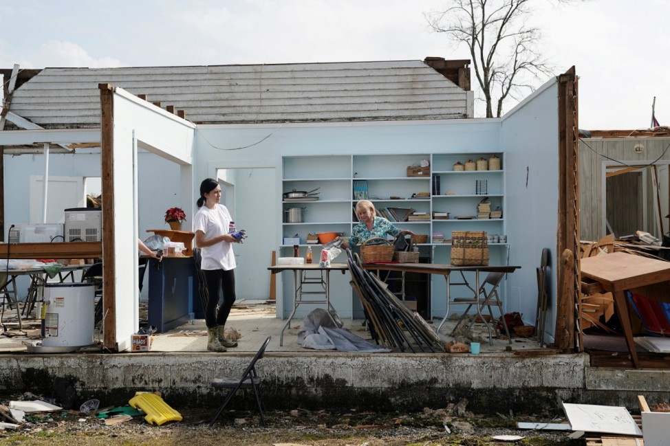 Kathy Poss salvages items from Ragan Chapel United Methodist Church the day after a string of tornadoes caused several fatalities in Ohatchee