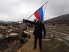 CRIMEA, RUSSIA - MARCH 18, 2021: A man holds the Russian flag during an event marking the 7th anniversary of the reunifi
