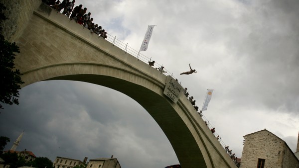 A man jumps off the newly rebuilt arch of 'Stari Most' (The Old Bridge) during the traditional diving competition in the southern Bosnian town of Mostar