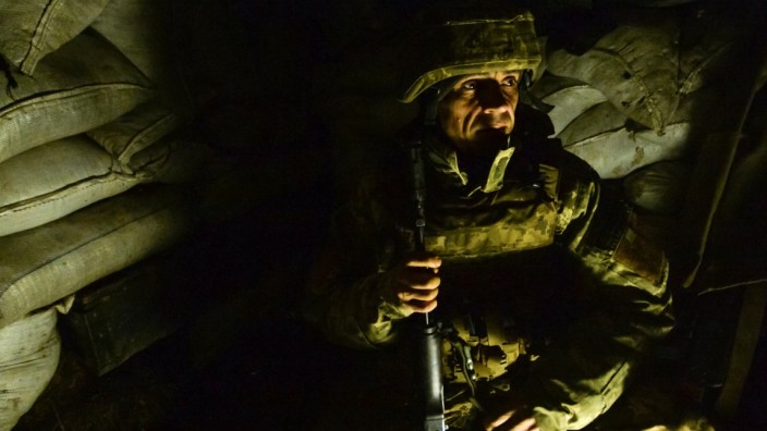 A service member of the Ukrainian armed forces is seen at fighting positions in Donetsk region
