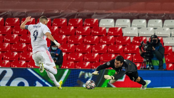 (210415) -- LIVERPOOL, April 15, 2021 -- Liverpool s goalkeeper Alisson Becker (R) makes a save from Real Madrid s Karim