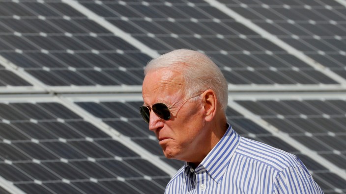 FILE PHOTO: Democratic 2020 U.S. presidential candidate Biden walks past solar panels in Plymouth