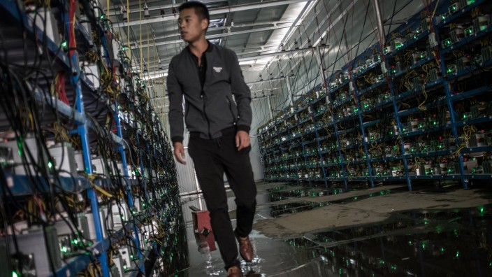 ABA CHINA SEPTEMBER 26 A worker inspects cryptocurrency mining rigs at a bitcoin factory on Sept