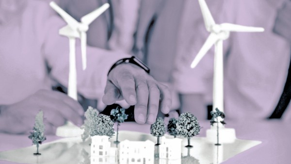 Close up of business people wind turbine model and houses on conference table model released Symbolf