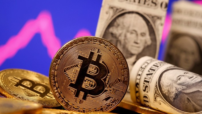 FILE PHOTO: FILE PHOTO: A representation of virtual currency Bitcoin and U.S. One Dollar banknotes are seen in front of a stock graph in this illustration