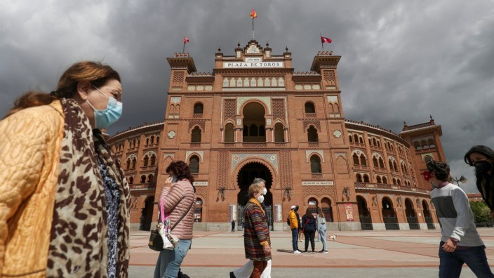 People walk past Las Ventas bullring ahead of the first bullfight since the start of the pandemic, in Madrid