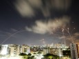 Streaks of light are seen as Israel's Iron Dome anti-missile system intercepts rockets launched from the Gaza Strip towards Israel, as seen from Ashkelon